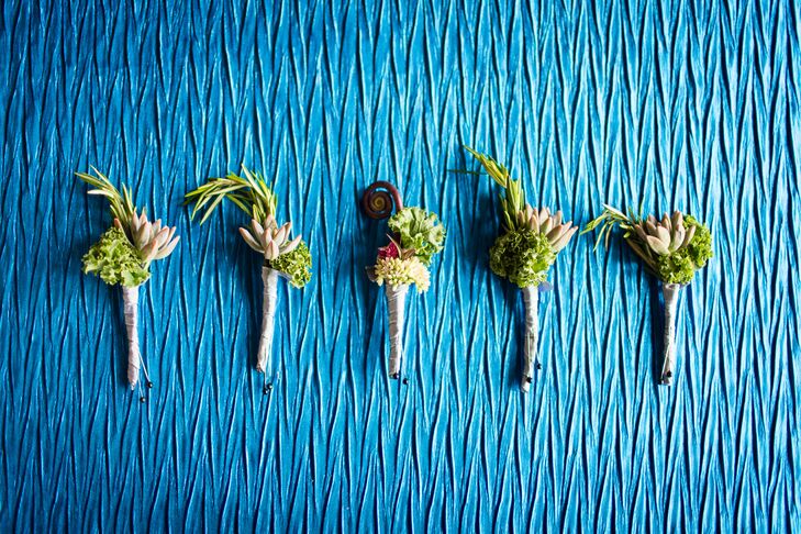 Brandon and the groomsmen wore rustic boutonnieres including succulents, cabbage and rosemary on their lapels. Brandon also had a fiddlehead fern to stand out from the other men.