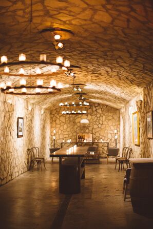 Rustic Winery Cave Reception Space with Iron Chandeliers