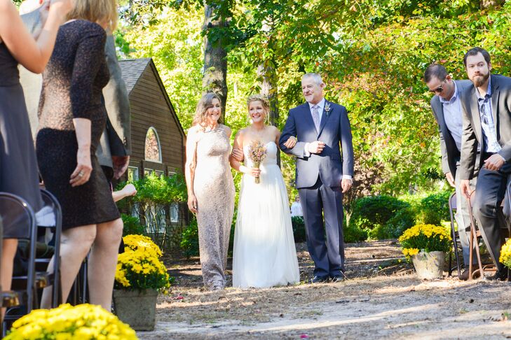 For Stephanie, some of the sweetest moments in their ceremony included when her parents walked her down the aisle and she saw Michael waiting at the end. Her father matched Michael with a navy blue suit and soft patterned tie. A similar wildflower boutonniere also marked his lapel.