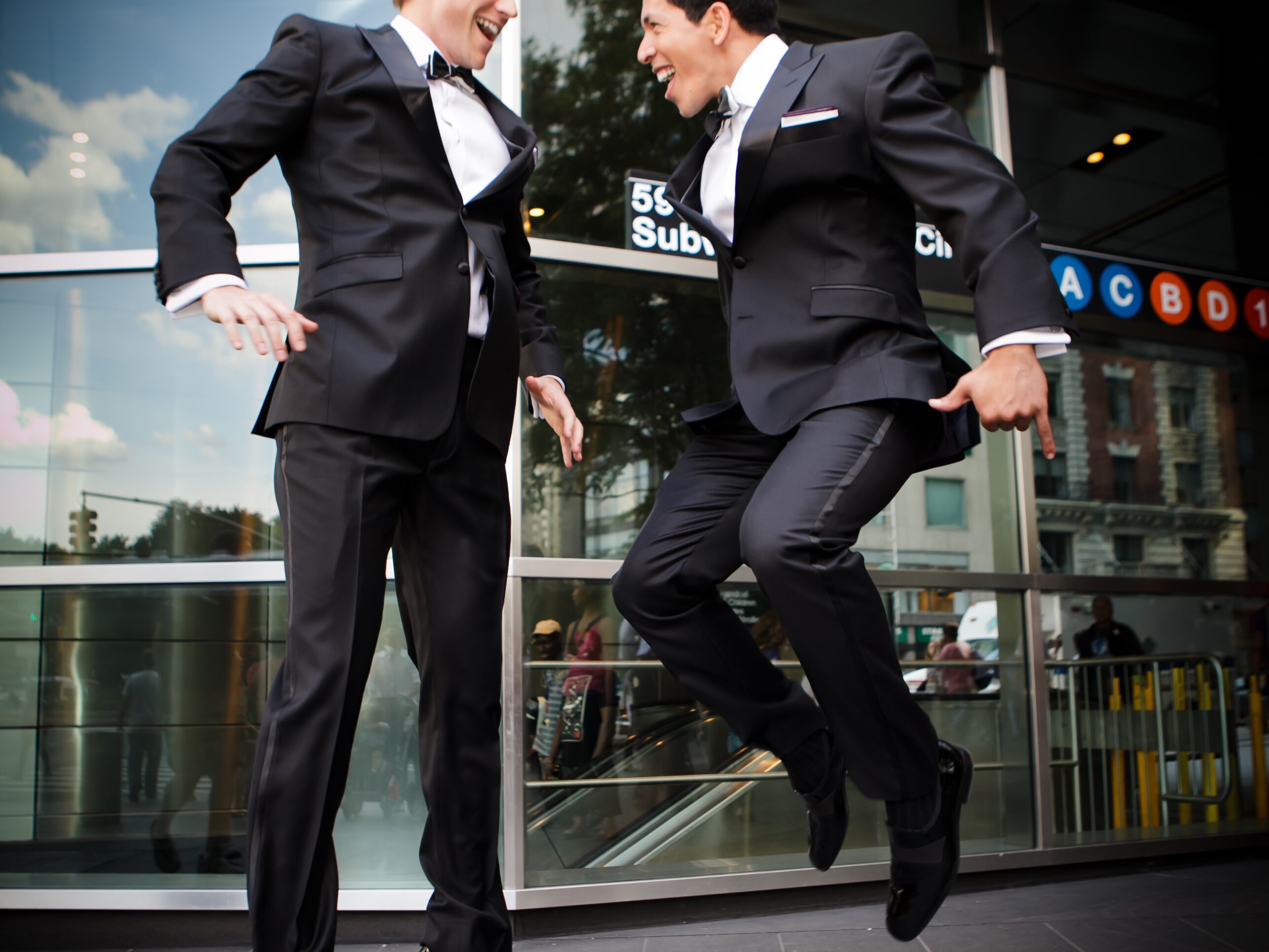 Grooms jumping for joy