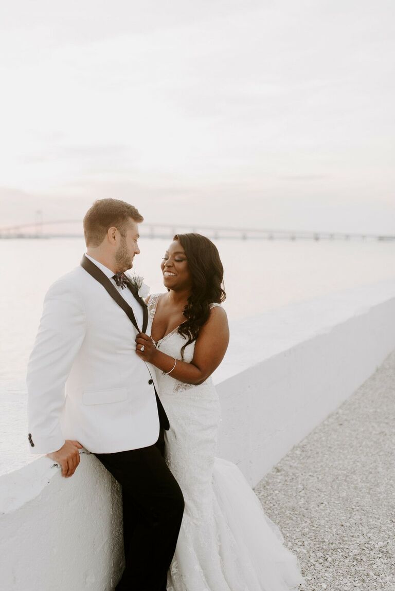 Waterfront portraits with bride and groom in white attire