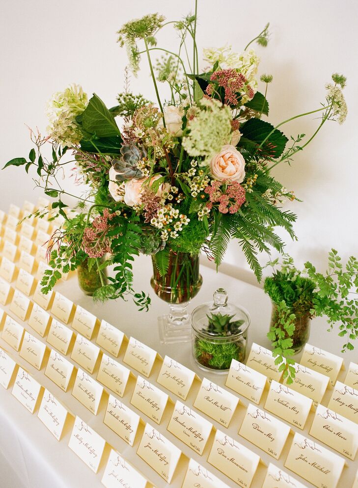 Epitome Papers created all the stationery, including the matching invitations and escort cards. They were printed on ivory paper with branchy brown typography. The table was decorated with textured florals created by Martha's Gardens, plus terrariums filled with succulents and moss.