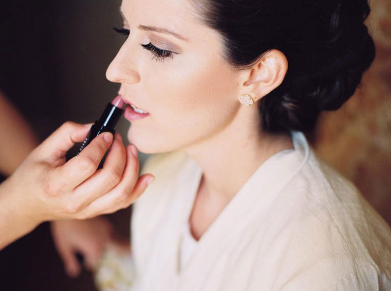 woman getting makeup done