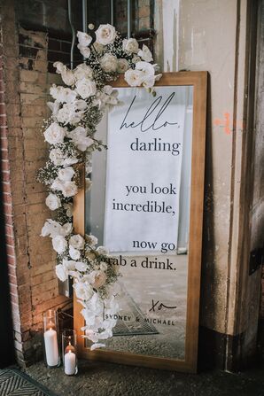 Formal Mirror Sign with White Flower Arrangement