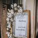 Formal Mirror Sign with White Flower Arrangement