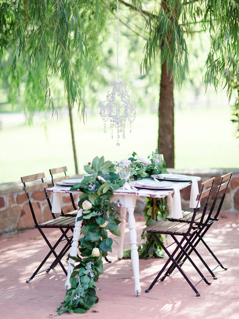 A Natural, Pastel Table Setting Accented With Greenery