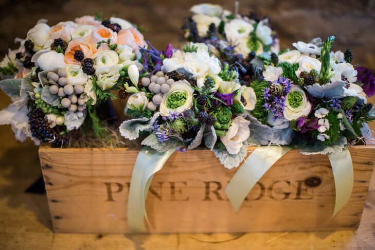 Bouquets were mixed with a variety of blooms, flowers and even fruit. Ranunculus, roses, scabiosa and silver brunia were mixed with dusty miller and greens, accented with fresh berries.