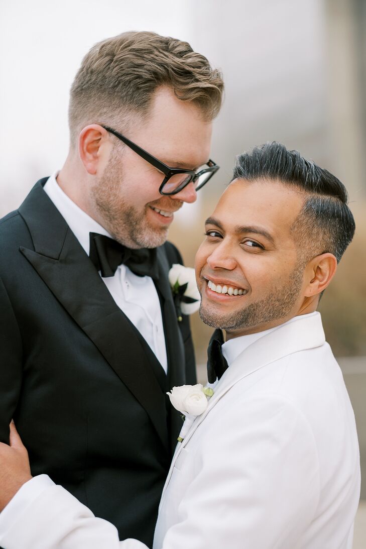 Groom With Glasses Hugging Groom in White Tuxedo