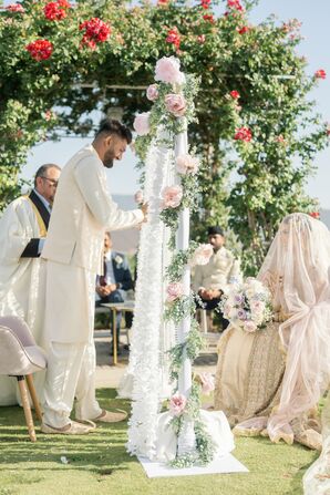 Pakistani-American Groom Opening Floral Curtain to See Bride During Nikkah Ceremony