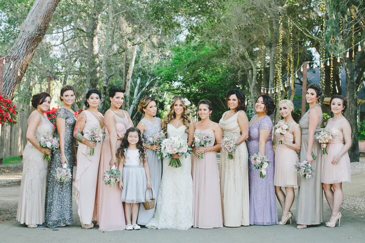 The young flower girl dressed in a white knee-length dress and a silver belt stood with Marisa and the rest of the bridesmaids. The ladies wore dresses in different styles, lengths and hues, creating a collection of pastels that matched the day's romantic vibe.
