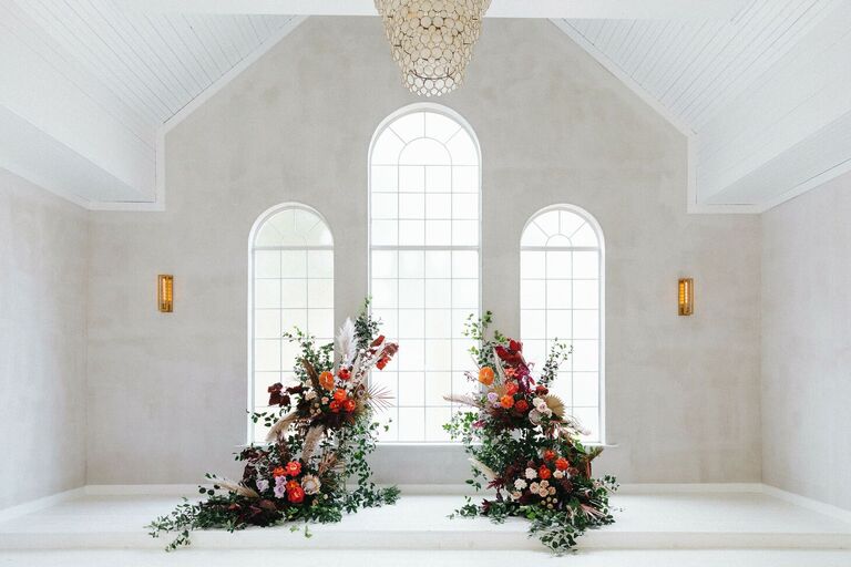 Altar with colorful deconstructed arch floral arrangement