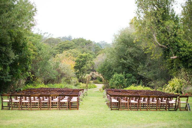 Danielle and Nicholas wed in a scenic field, under a handcrafted arch, in front of 150 guests. Shepherd's hooks holding succulents decorated the aisle.
