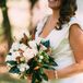 Since Molly's favorite flower, peonies, weren't in season during the time of her wedding, Andrea from LynnVale Studios helped her craft the perfect bouquet. She used ivory and blush roses that resembled peonies and paired them with leaves from Ryan's parents' magnolia tree, since Molly also loves magnolia. She also incorporated small, white dahlias into the bouquet as well as basil leaves, which had the arrangement smelling fresh all day.