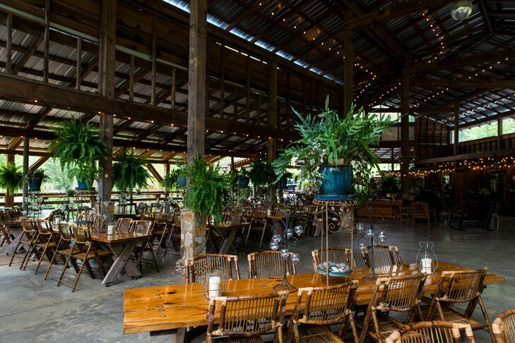 Ashley and Miguel's wedding reception under the pavilion at the Neverland Farms featured various types of decor including lush greenery arrangements. "My favorite decor from the day was all of the greenery," Ashley says. "There were plants and flowers everywhere."