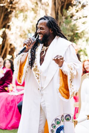 Groom in Custom Fashion-Forward Outfit Singing Original Song at Ceremony