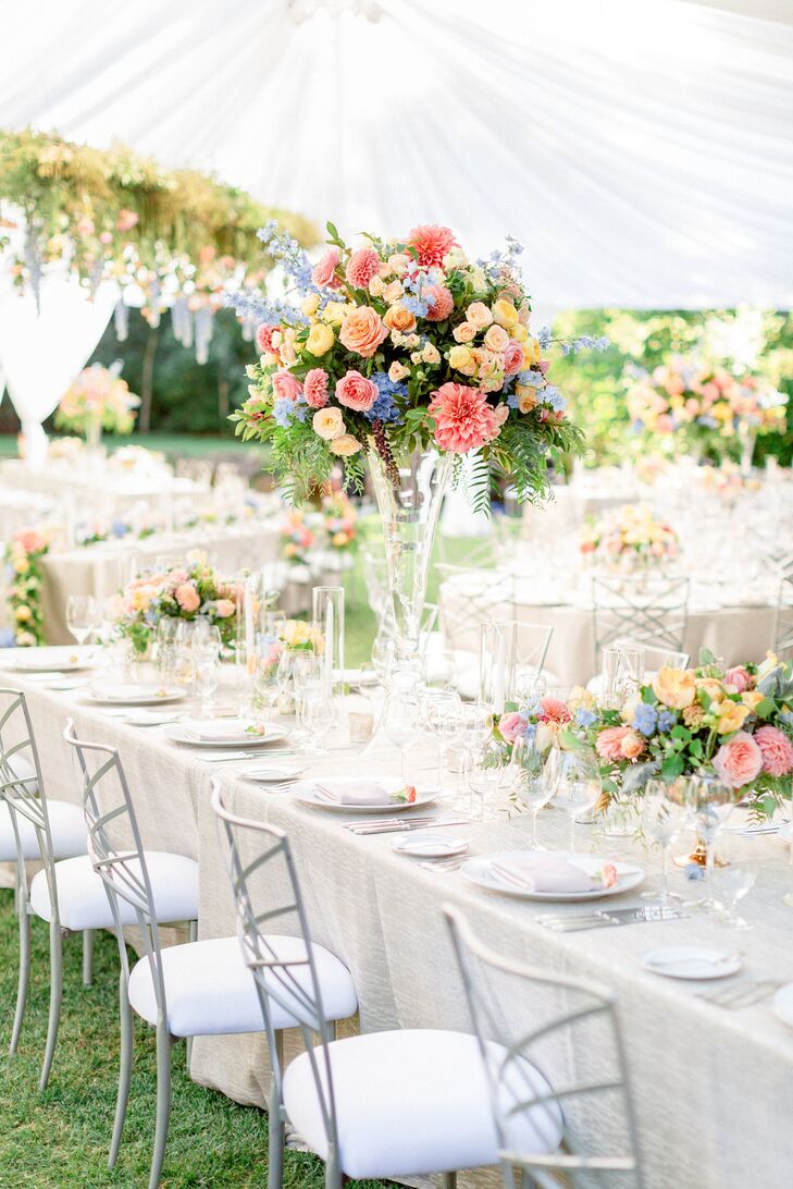 Dining Tables with Tall Floral Centerpieces and Ivory Linens