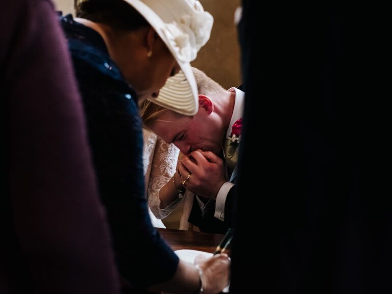Groom kissing bride's hand