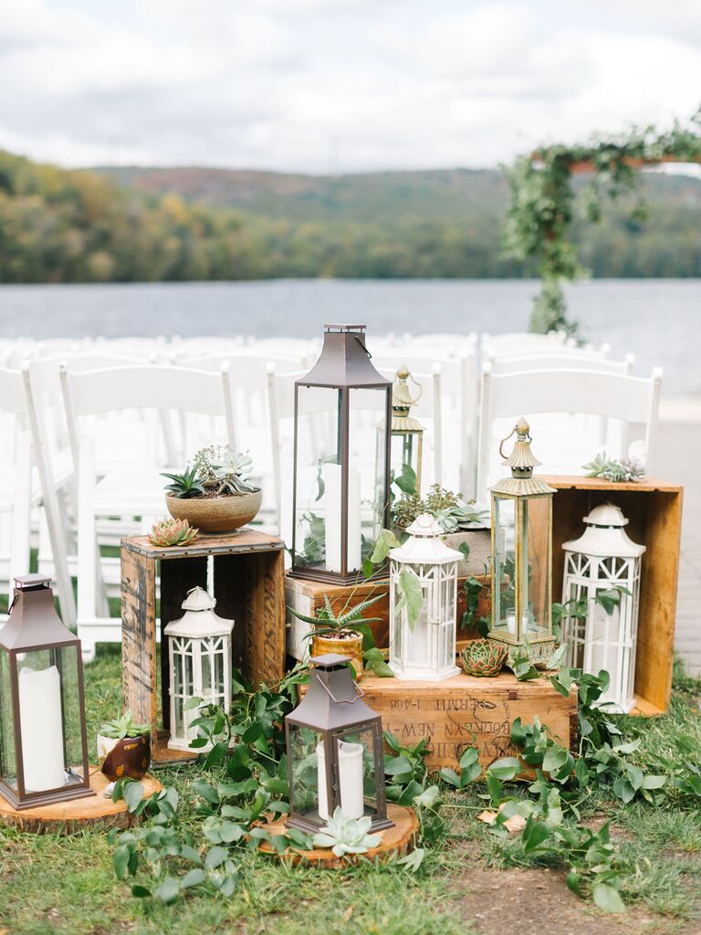 Cluster of distressed antique lanterns as wedding aisle decorations
