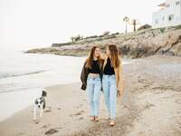 same sex couple walking on beach