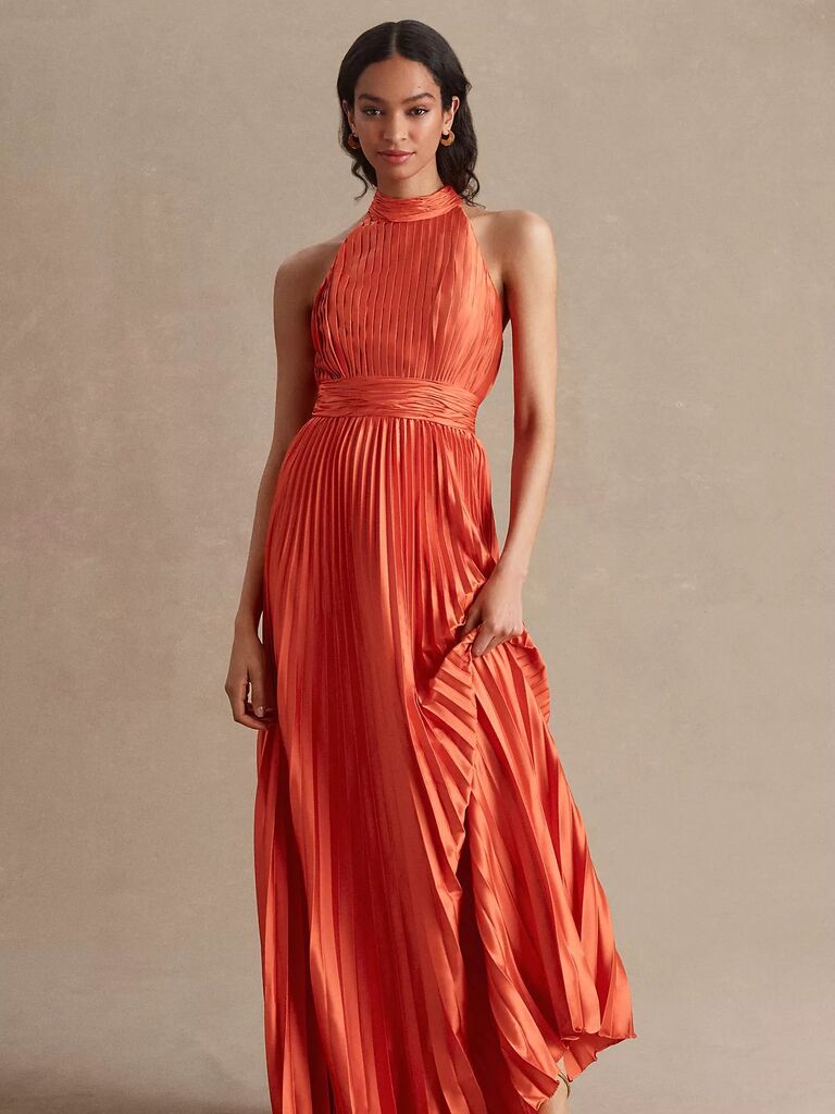 Orange pleated dress for mother of the bride.