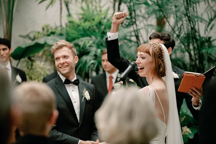 Bride, Groom and Officiant at Altar, Smiling and Laughing Facing Guests During the Ceremony