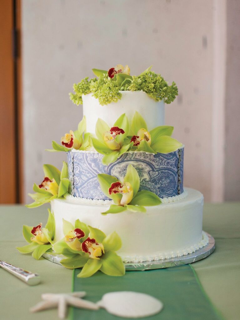 three tier fondant wedding cake with blue stencil middle tier and green orchids