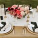 Black and White Dining Table Scheme with Gold Accents and Pink Centerpiece