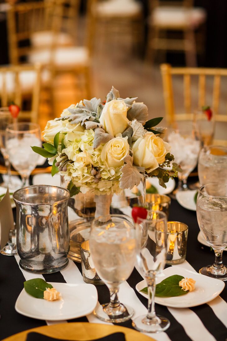 The bridal bouquet served as the centerpiece for the sweetheart table, filled with a variety of ivory roses and hydrangeas.