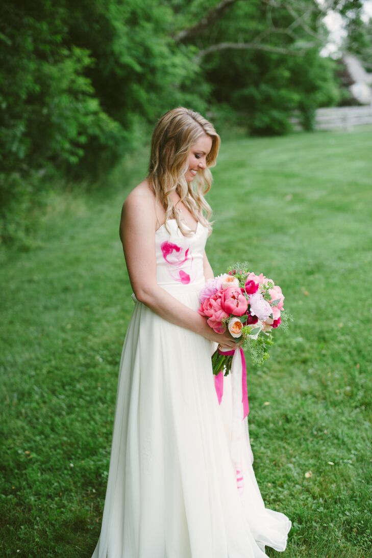 Lauren wanted a dress with a touch of color, which she found in the white strapless Meki Couture gown. The custom-made dress had vibrant shades of pink splashed across the white bodice, matching Lauren's pink bouquet.