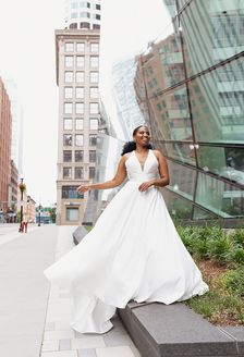 Bride in V-neck wedding dress on city street