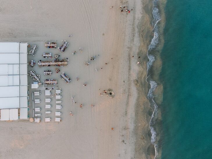Aerial Photo of Beach, Ocean Venue With Long Tables at French Rehearsal Dinner