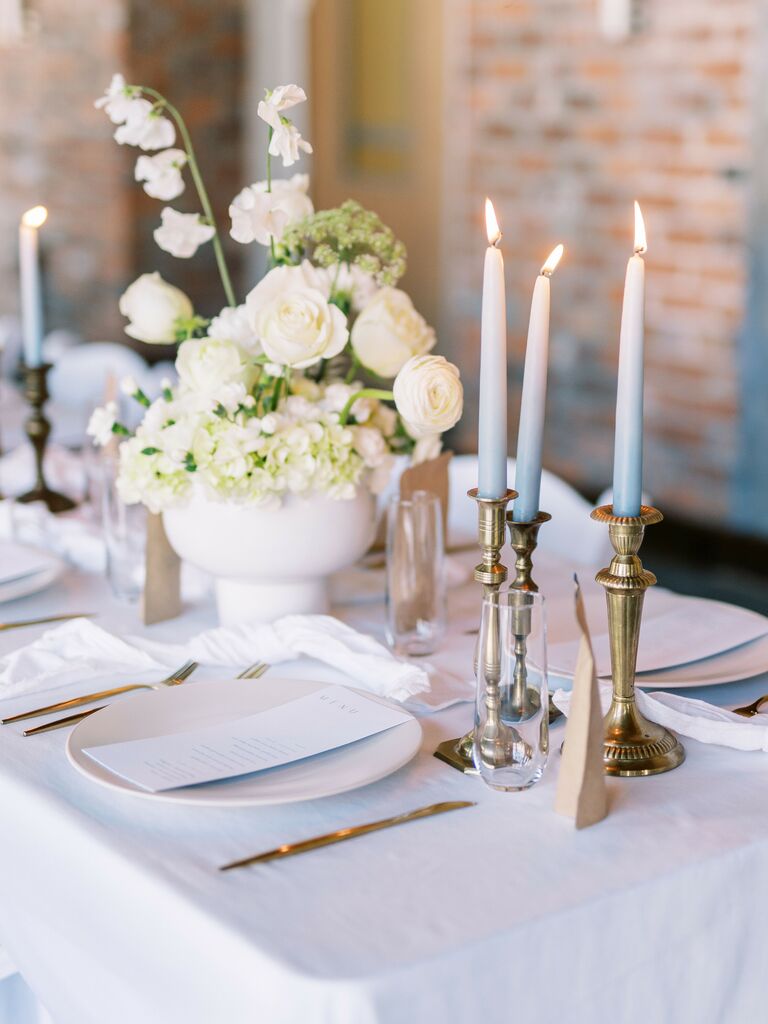 wedding tablescape with pastel blue and white ombre taper candles in gold candlesticks