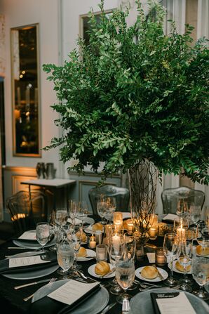 Luxurious Round Table With Black Linen, Low Taper Candles, Tall Greenery Centerpiece