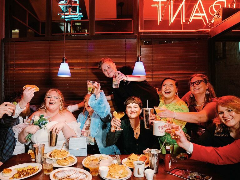 Friends celebrate a wedding at an intimate restaurant. 