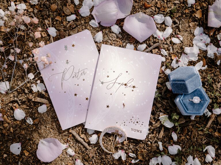 Light pink wedding vow books with celestial-themed star print