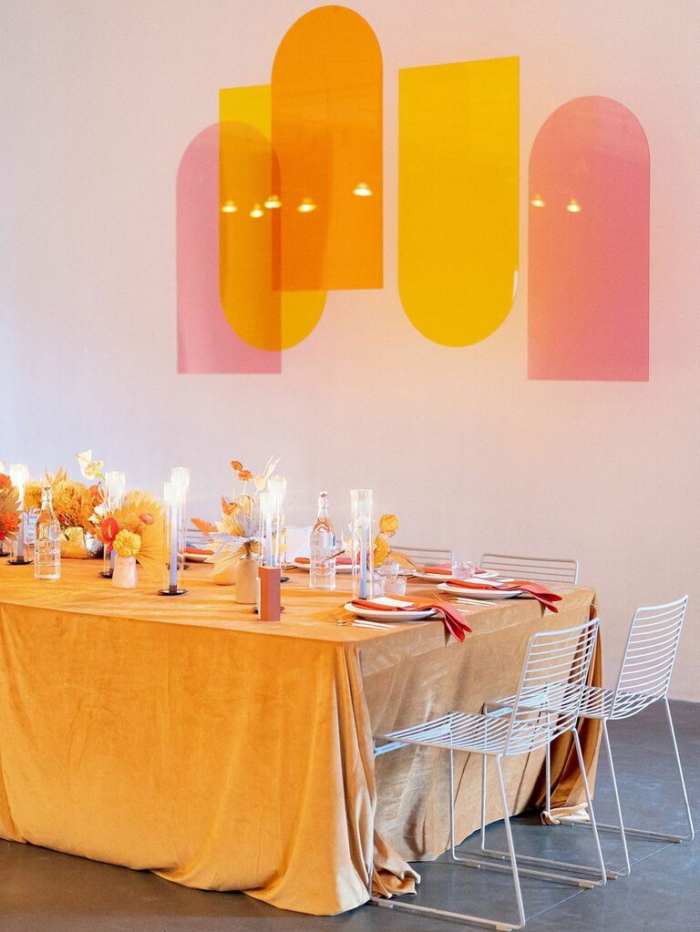 Orange velvet tablecloths at vintage bohemian wedding reception