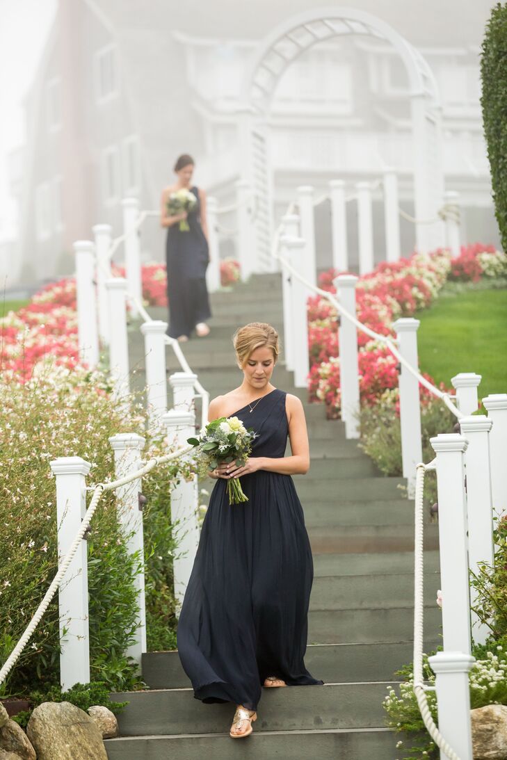 For a cohesive, elegant look, Alexandria had her bridesmaids wear the same navy, chiffon gown in an one-shoulder A.-Line silhouette.