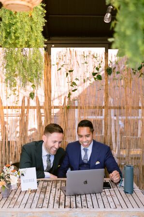 Grooms Video Chatting During Wedding Reception