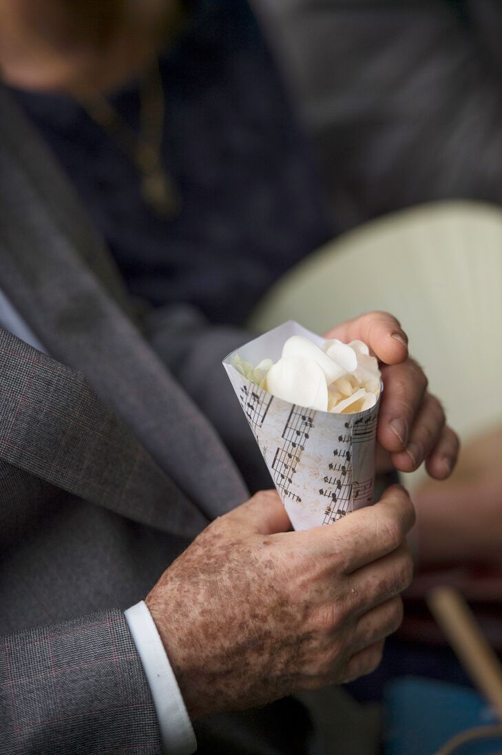 Rachel and Jacob left no detail overlooked when it came to planning their wedding. Instead of the traditional rice toss after the ceremony, guests tossed ivory rose petals as the couple walked up the aisle. Rachel and Jacob gave their family members and friends with paper cones made from sheet music filled with petals, a nod to the couple’s musical beginning.