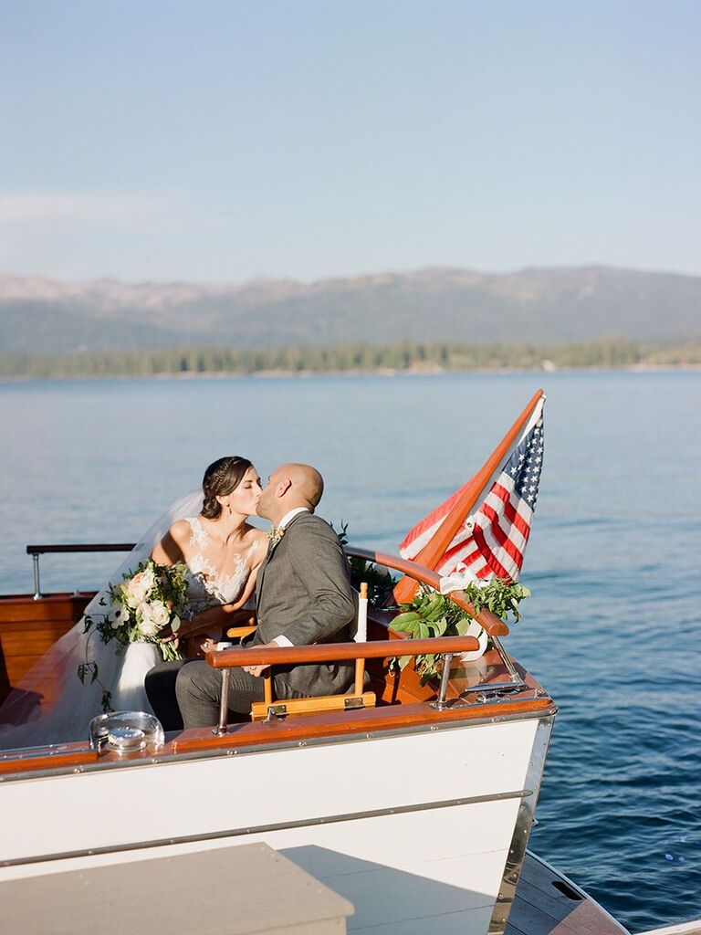bride and groom kissing in boat