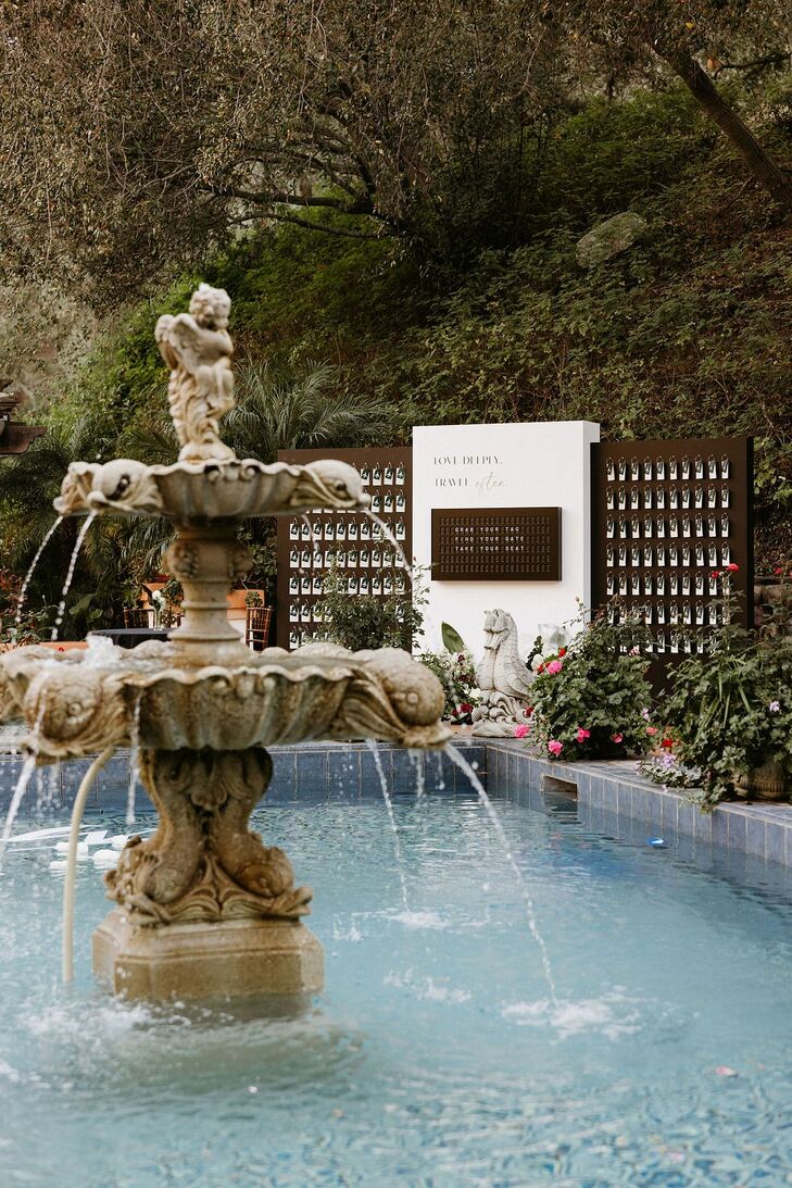 Ornate Fountain and Unique Black-and-White Escort Card Display at Garden Venue