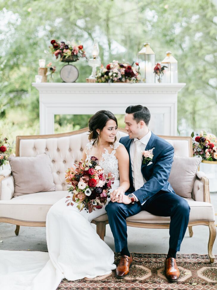 Classic Couple Sitting in Vintage Lounge Area Decorated with Fall Blooms