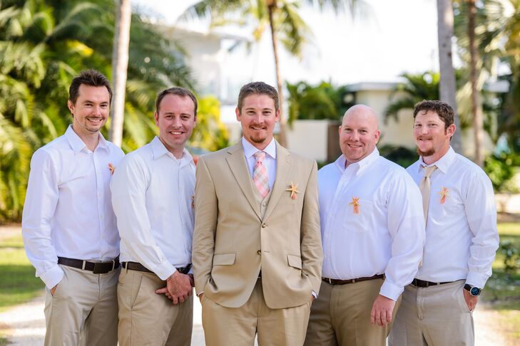 Damien was dressed in a khaki suit and pink tie while his groomsmen wore khaki pants and classic white shirts. All were accented with a starfish boutonniere I made by the bride, Kristen says.