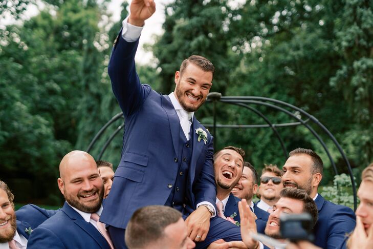Groomsmen Lifting up Groom and Cheering