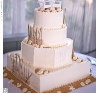 The creative groom designed the cake himself, mixing different shapes for a whimsical look. It was iced in white buttercream and decorated with brown sugar “sand” and white chocolate shells, starfish, and other sea creatures.  To bring their theme of comfortable sophistication full circle, the bride and groom added small white Adirondack chairs as a cake topper, personalized with their names in silver pen.
