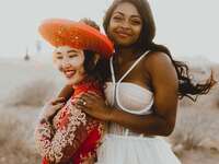 brides posing for wedding portraits in the dessert