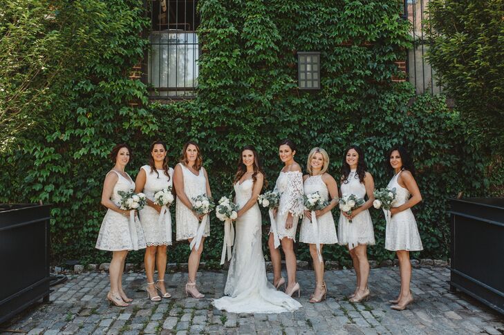 Keeping with the day's crisp white palette, each of Nancy's bridesmaids wore a different lacy white knee-length dress. "I wanted them to like their dress and feel comfortable," Nancy  says. Bouquets were made with white peonies and roses and eucalyptus and lemon leaves.