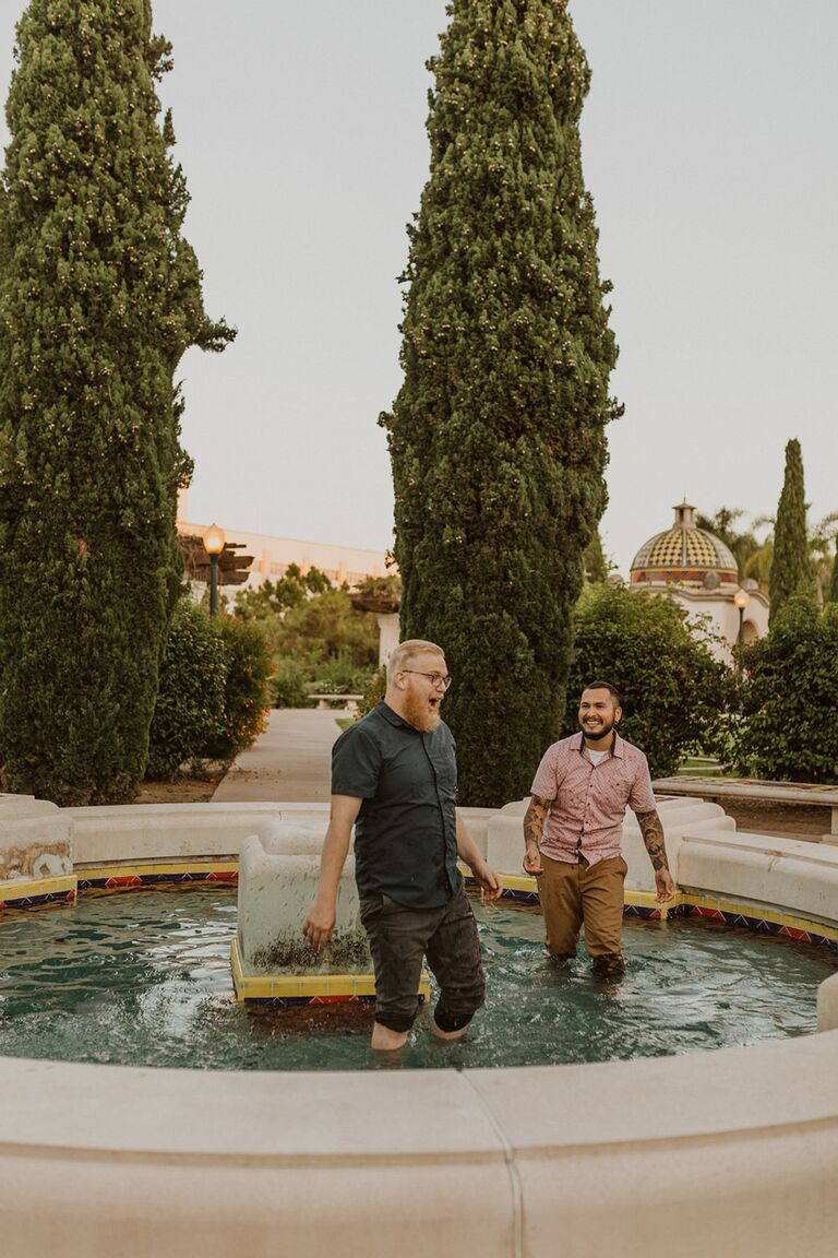 Couple jumping in fountain during San Diego engagement session