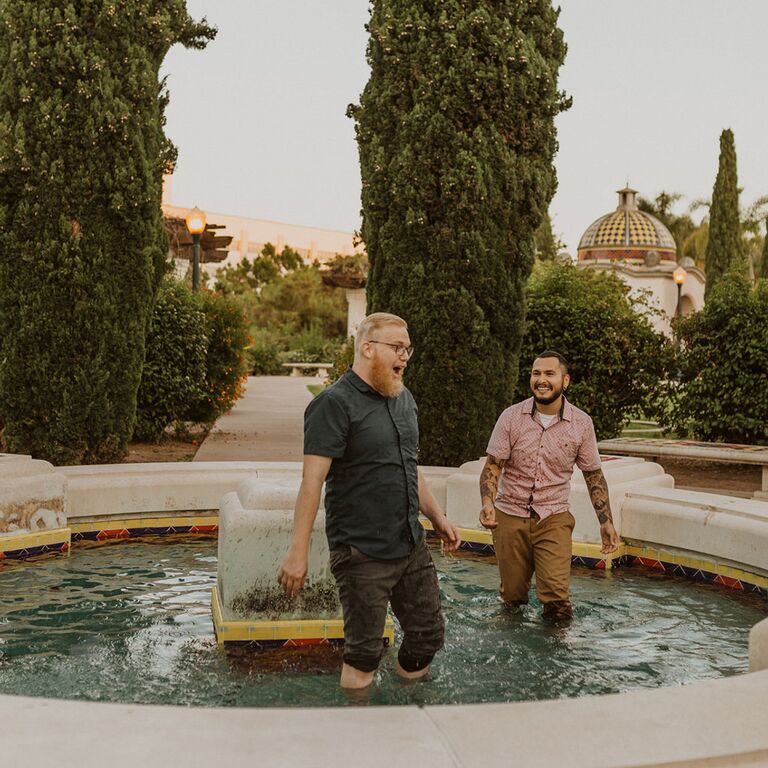 Couple jumping in fountain during San Diego engagement session