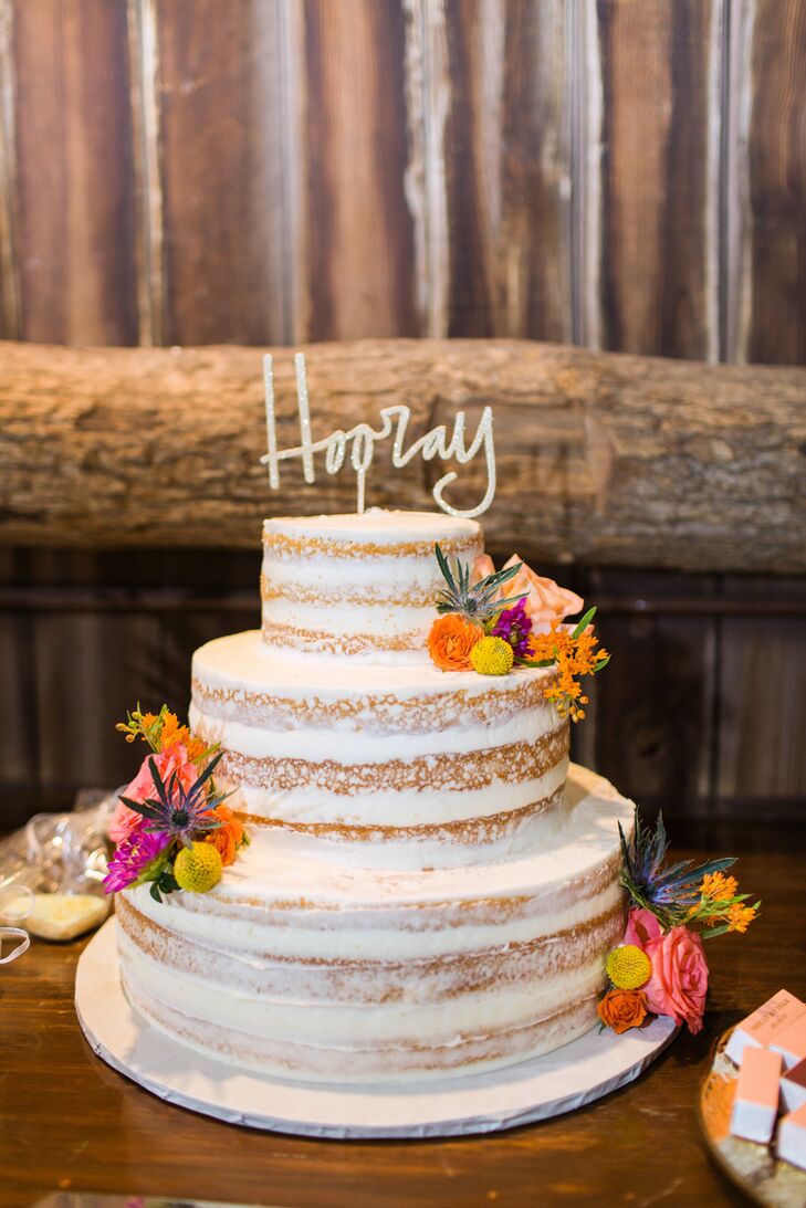 Dreamscape Desserts whipped up this vanilla naked cake with a raspberry filling for Molly and Visar’s reception. Bright flowers and a cheeky cake topper made this treat even sweeter. “It was exactly what we wanted,” Molly says of the three-tier confection.